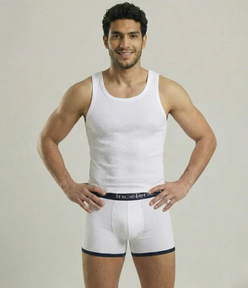 Man wearing a white tank top and underwear set on a plain background
