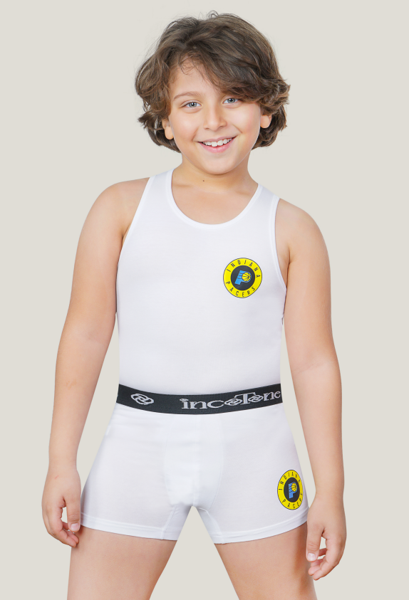 Child wearing a white sleeveless top and shorts with a logo, on a plain background
