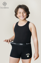 Child wearing a black tank top and shorts with 'incotone' branding on a plain background