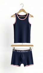 Navy tank top and boxer with pink trim on hangers against a white background
