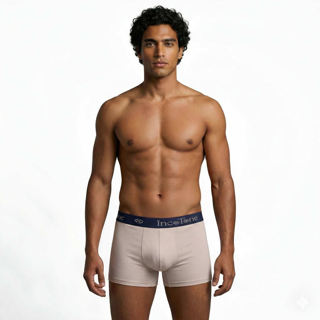 Man wearing beige underwear with a visible brand logo on a white background